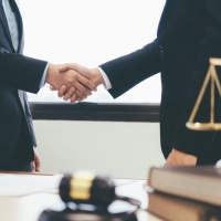 Law and Legal services concept. Law and Legal services concept. Lawyer and attorney having team meeting at law firm. Lawyer and businessman handshake.